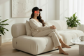 Woman wearing black LED red light therapy cap for hair and scalp care